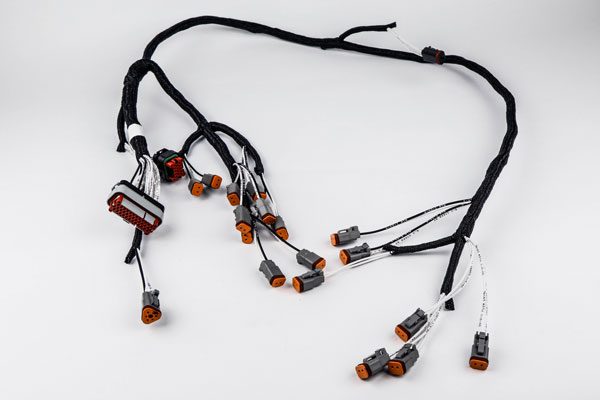 wiring-harnesses-1 a red hose, possibly a fire hose, lying on a white surface