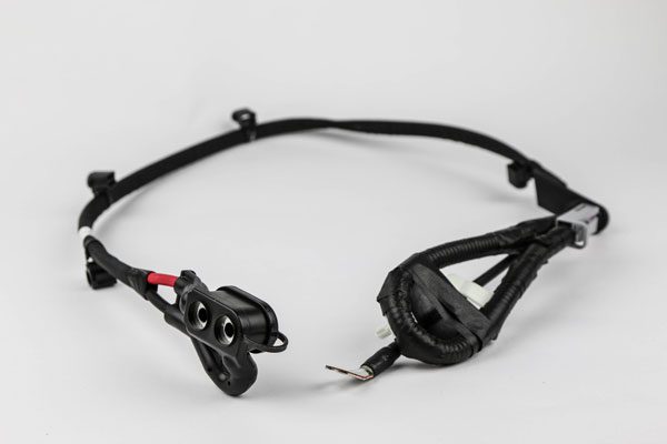 wiring-harnesses-cable-harnesses a red hose, possibly a fire hose, lying on a white surface