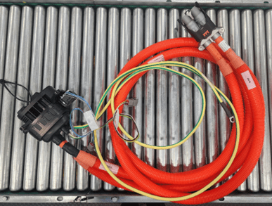 HV assembly a red hose, possibly a fire hose, lying on a white surface